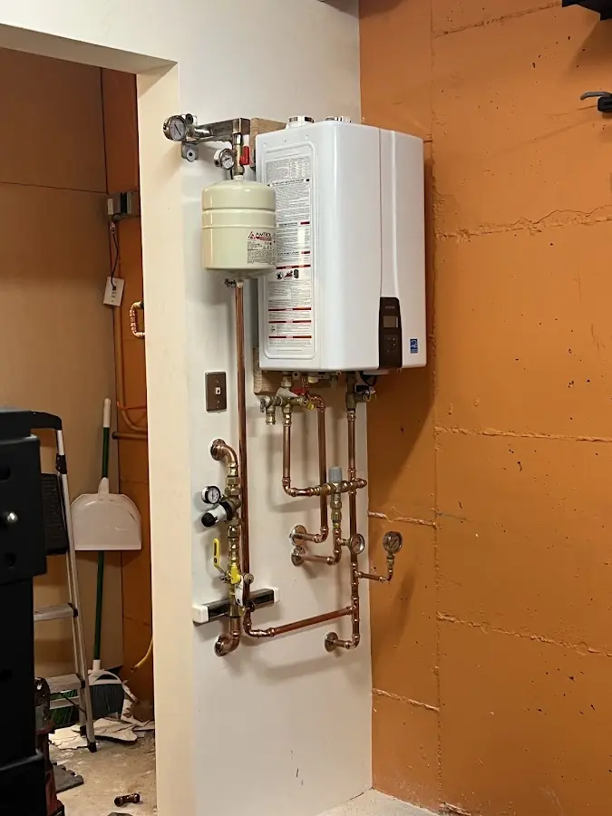 Plumbing technician inspecting water heater connections in Palm Springs North